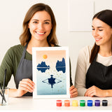 Deux personnes souriantes présentent une œuvre réalisée avec le pochoir artistique Hanoï de Panash Art.
Le tableau montre une silhouette sur l’eau devant des montagnes, créée à partir du kit créatif Panash Art avec peinture et pochoir.